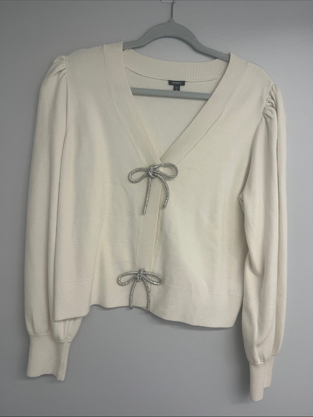 Express Cream V‑Neck Cardigan with Metallic Bow Ties
